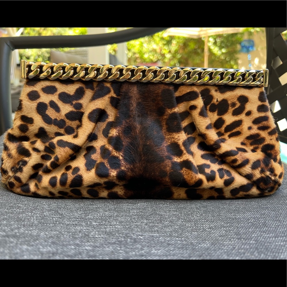 Christian Louboutin ponyhair clutch with gold chain and black patent detailing.
